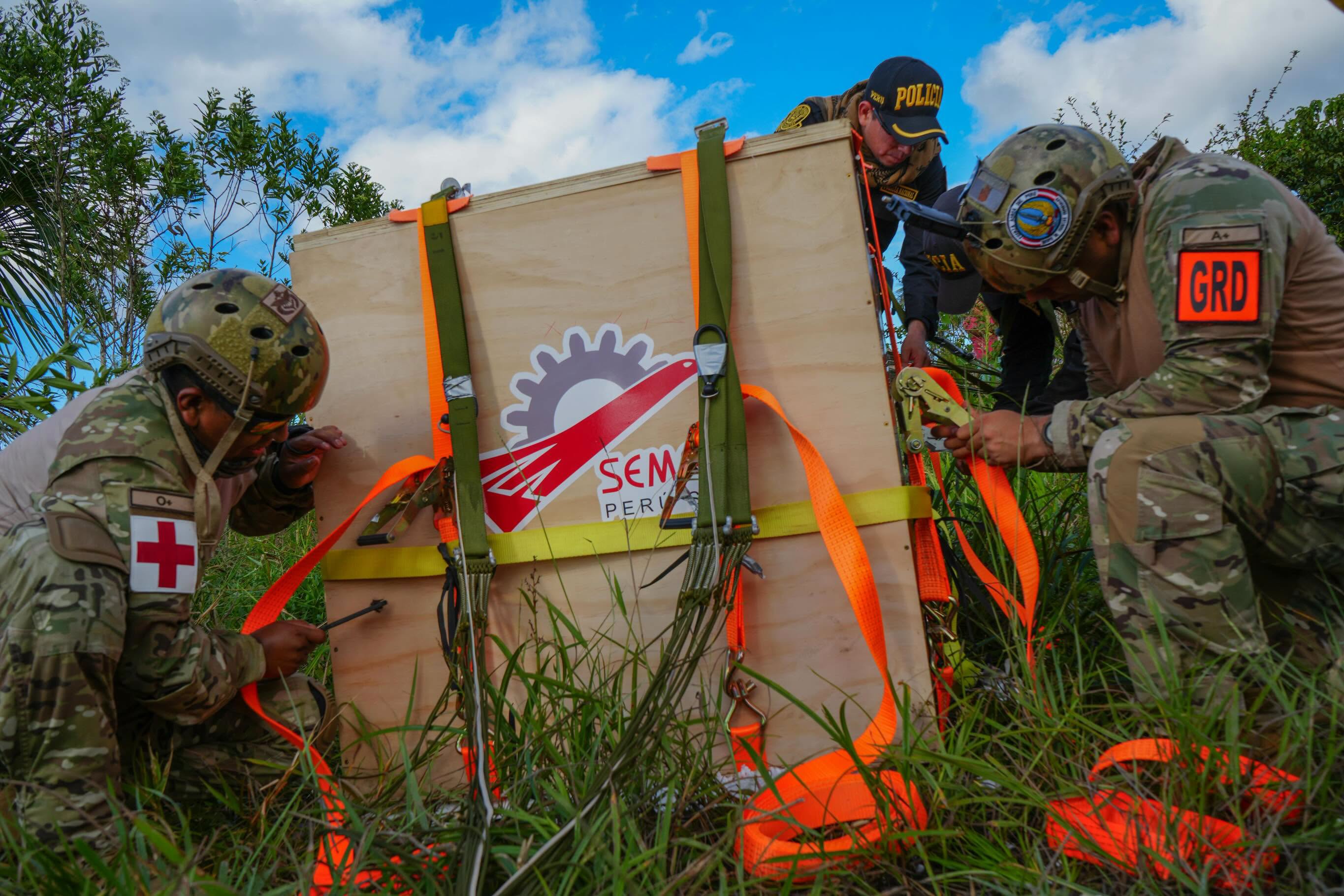 Peruvian Air Force crew rigging an airdrop crate in the Amazon